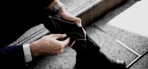 Person holding an empty wallet while dealing with financial stress and bankruptcy in San Diego